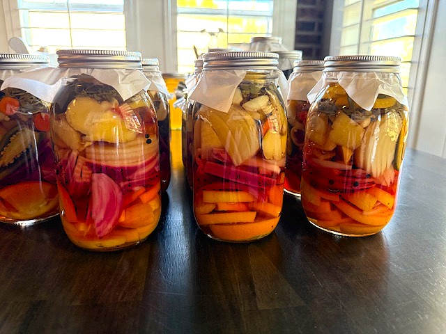 Homemade fire cider in glass jars on kitchen counter